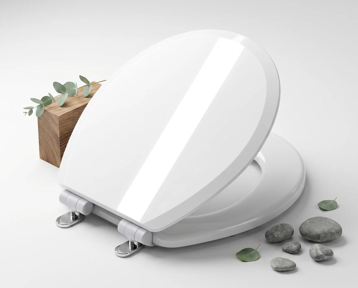 Topseat white round wood toilet seat with high-gloss StainShield finish, displayed with natural wood block and stones.