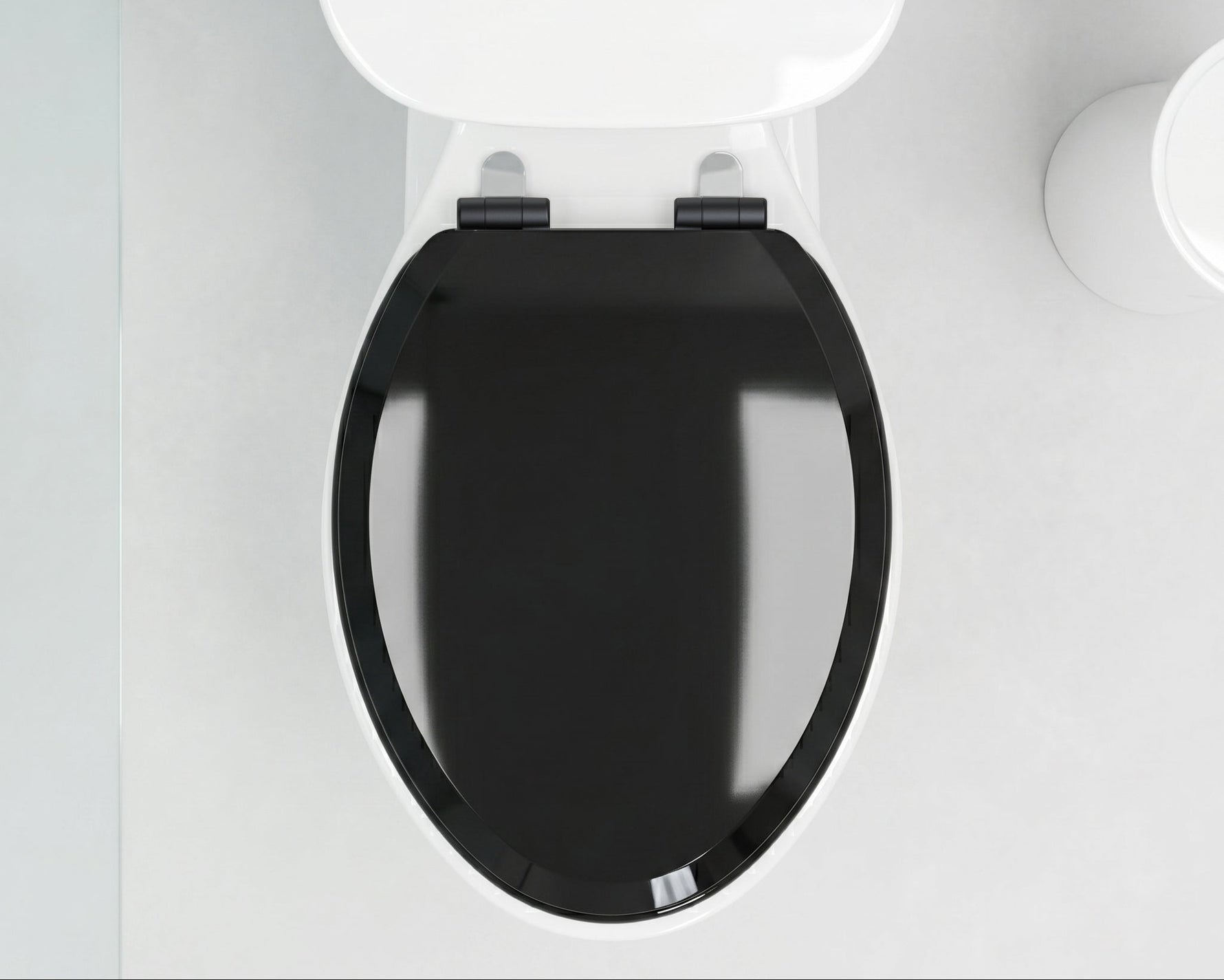 Toilet with black seat and white cover in a bathroom setting