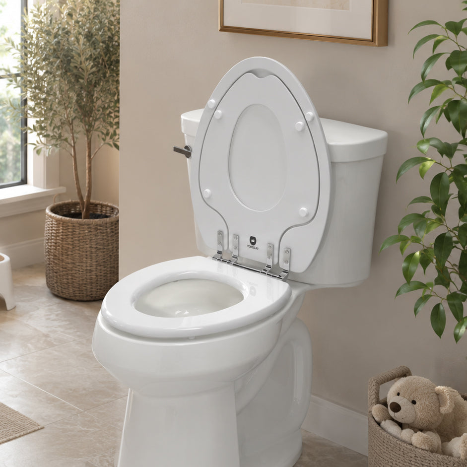 Topseat TinyHiney Potty 2-in-1 potty training toilet seat with built-in child seat installed on a residential toilet in a modern family bathroom.